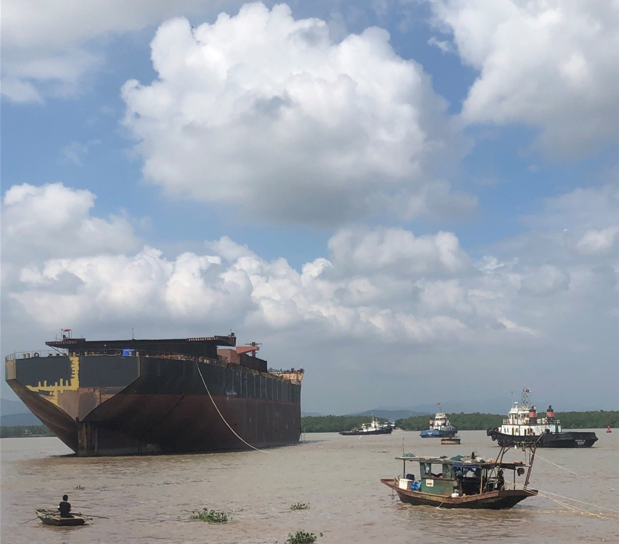 TCM tugboat assists towing a Hull in Hai Phong channel